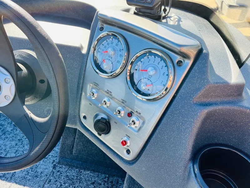 Slide: The Image of Dashboard of 2025 Tracker Pro Guide V-16 SC boat with gauges and controls. - 21