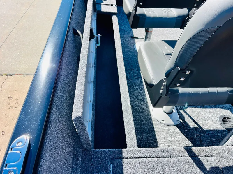 Slide: The Image of 2025 Tracker Pro Guide V-16 SC boat interior with seating and storage compartment. - 22