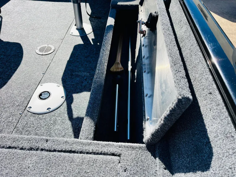 Slide: The Image of 2025 Tracker Pro Guide V-16 SC boat interior with open storage compartment. - 23