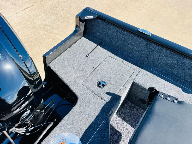 Slide: The Image of 2025 Tracker Pro Guide V-16 SC boat interior with storage compartment and motor. - 25