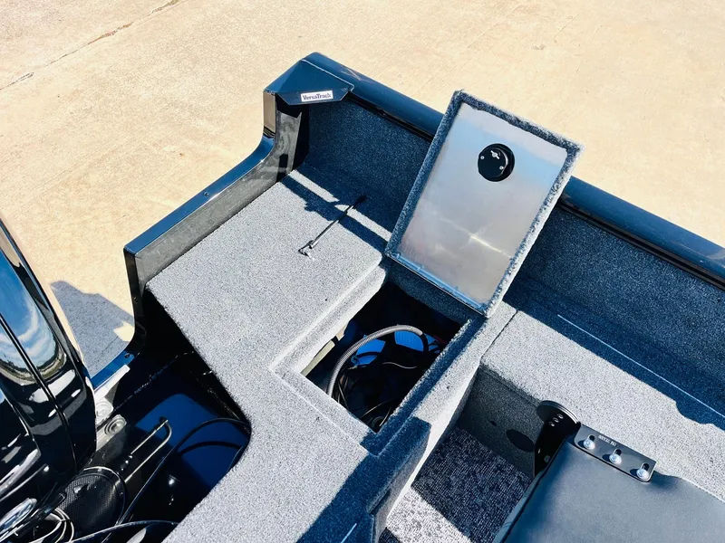 Slide: The Image of 2025 Tracker Pro Guide V-16 SC boat interior with storage compartment open. - 26