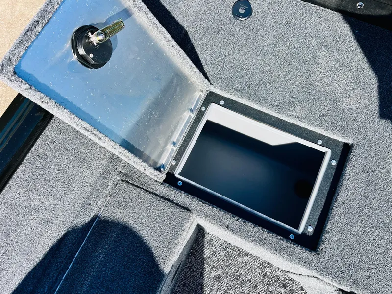 Slide: The Image of 2025 Tracker Pro Guide V-16 SC boat storage compartment with open lid. - 29