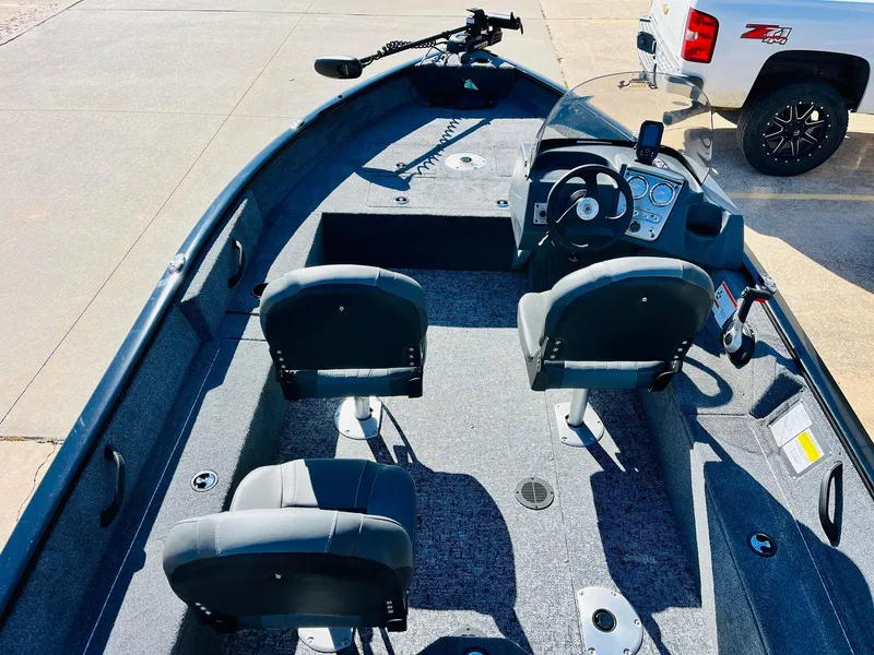Slide: The Image of 2025 Tracker Pro Guide V-16 SC boat interior with seating and steering console. - 7