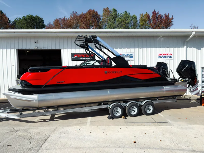 Slide: The Image of 2024 Godfrey XP 27' pontoon boat with twin 400HP engines on a trailer. - 0