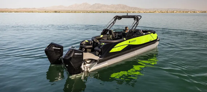 Slide: The Image of 2024 Godfrey XP 27' boat with twin 400HP engines on a serene lake. - 10
