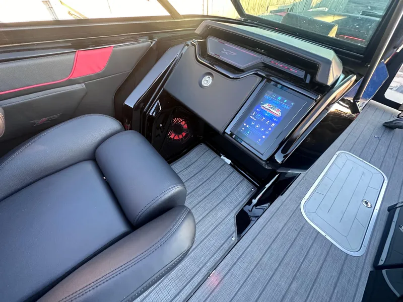 Slide: The Image of Luxurious 2025 Godfrey XP 2700 W boat interior with advanced control panel and sleek seating. - 7