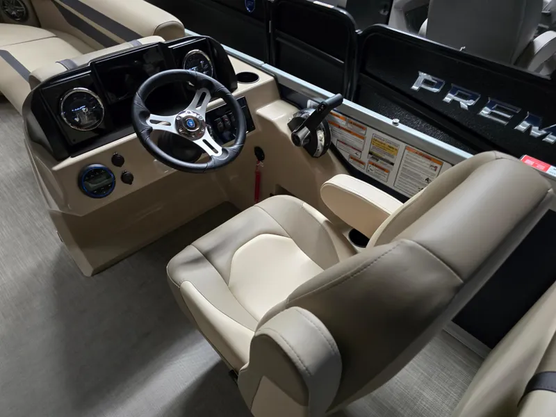Slide: The Image of 2025 Premier 220 Sunscape RF boat interior with steering wheel and beige seating. - 12