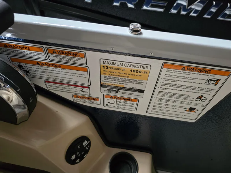 Slide: The Image of Warning labels and capacity limits on 2025 Premier 220 Sunscape RF boat. - 13
