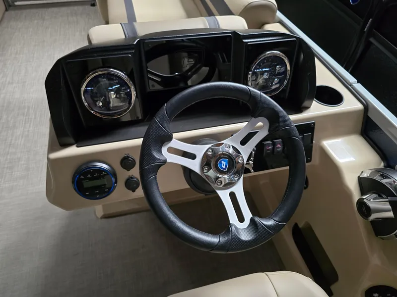 Slide: The Image of 2025 Premier 220 Sunscape RF boat dashboard with modern steering wheel and controls. - 14