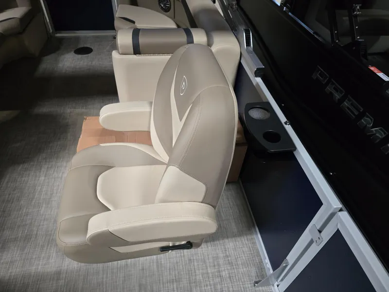 Slide: The Image of Premier 220 Sunscape RF 2025 boat interior with beige captain's chair and console. - 7