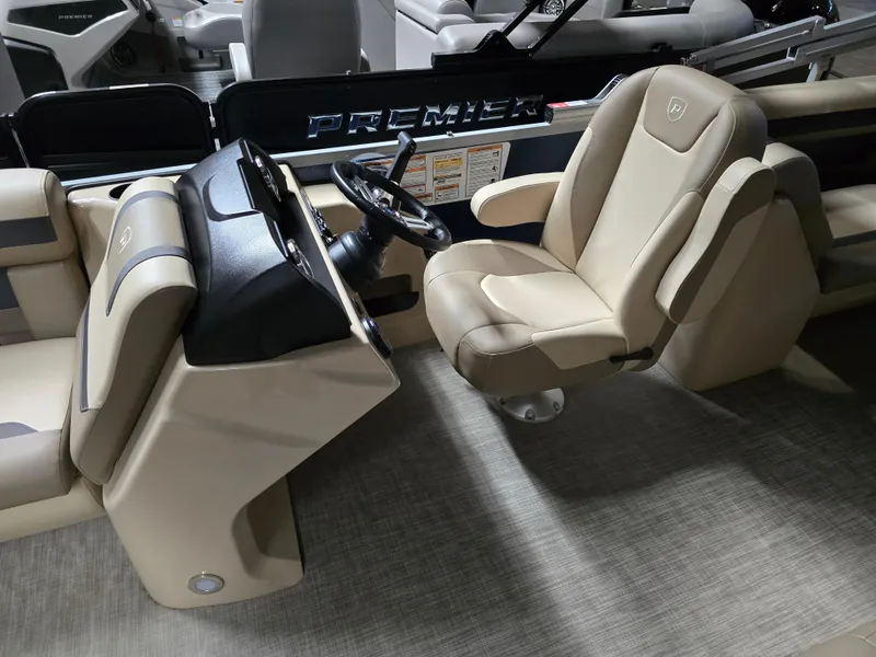 Slide: The Image of 2025 Premier 220 Sunscape RF boat interior with beige captain's chair and steering console. - 8