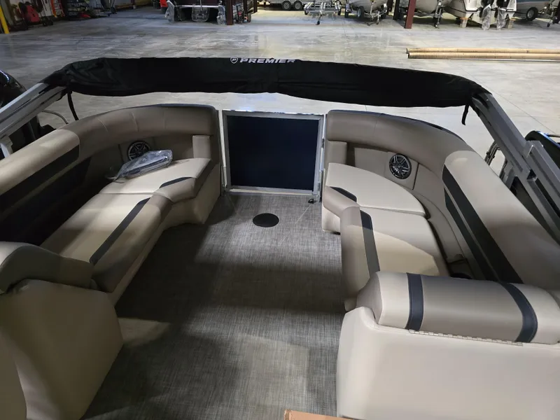 Slide: The Image of 2025 Premier 220 Sunscape RF boat interior with beige seating and carpeted floor. - 9