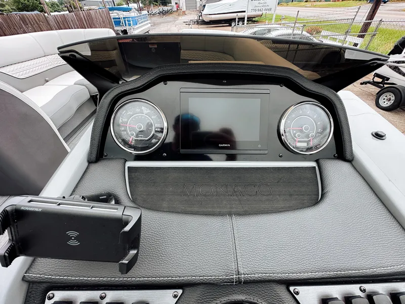 Slide: The Image of 2025 Godfrey Monaco Tritoon dashboard with modern gauges and touchscreen display. - 12