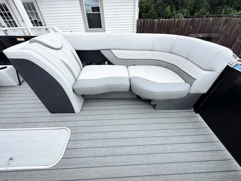 Slide: The Image of 2025 Godfrey Monaco 23' Tritoon with dual flip lounge seating, gray upholstery, and modern design. - 15