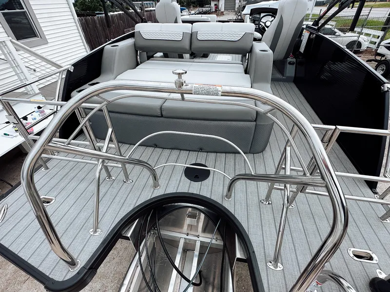 Slide: The Image of 2025 Godfrey Monaco 23' Tritoon with dual flip lounge, sleek design, and modern features. - 16