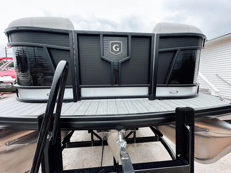 Slide: The Image of 2025 Godfrey Monaco 23' Dual Flip Lounge Tritoon, rear view, sleek design, black and silver finish. - 19