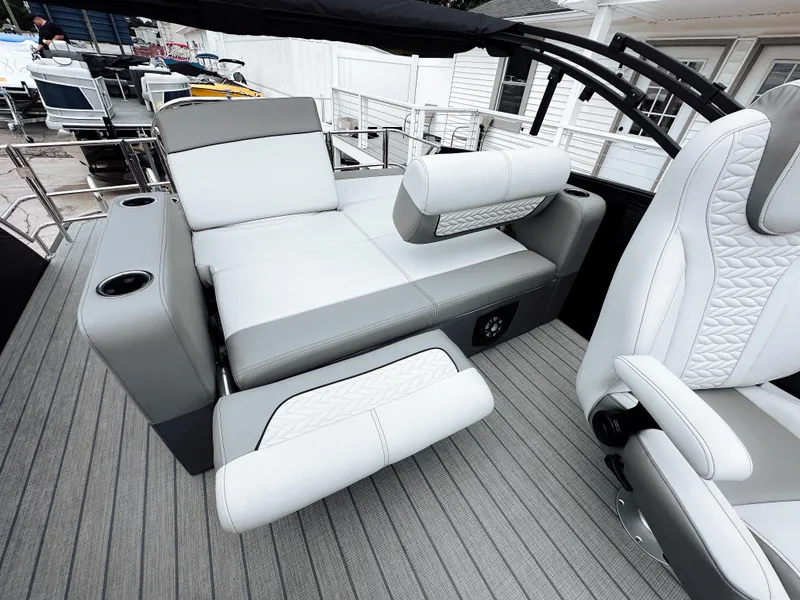 Slide: The Image of 2025 Godfrey Monaco 23' Tritoon with dual flip lounge seating, featuring sleek gray upholstery. - 5