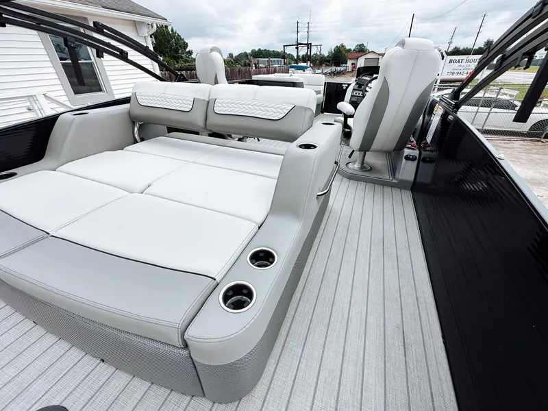 Slide: The Image of 2025 Godfrey Monaco 23' Tritoon with dual flip lounge seating and modern interior design. - 8