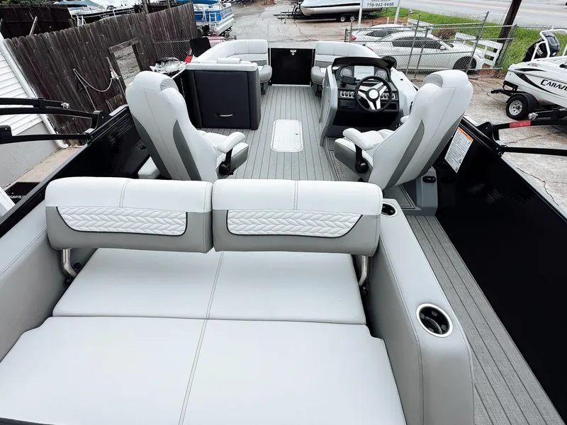 Slide: The Image of 2025 Godfrey Monaco 23' Tritoon with dual flip lounge seating, modern interior design. - 9