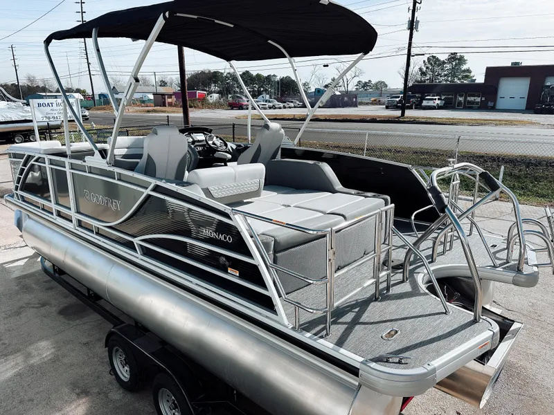 Slide: The Image of 2025 Godfrey Monaco 23' Dual Flip Lounge Tritoon with sleek design and spacious seating. - 13