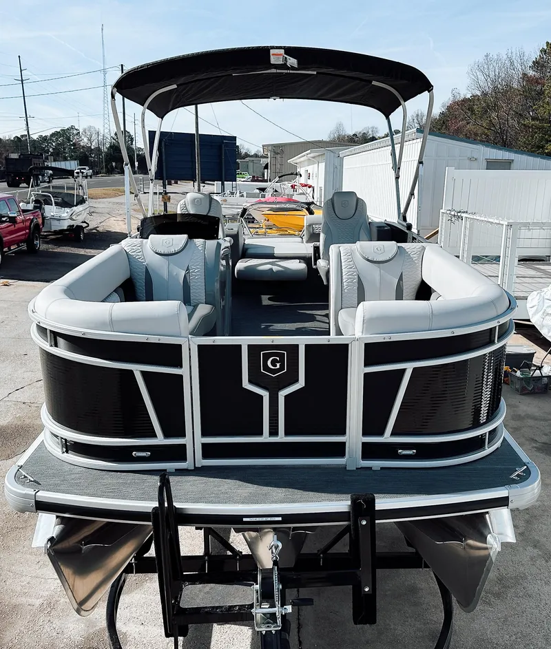 Slide: The Image of 2025 Godfrey Monaco 23' Dual Flip Lounge Tritoon, sleek design, spacious seating, outdoor setting. - 14