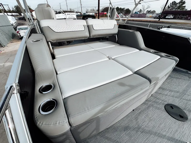 Slide: The Image of 2025 Godfrey Monaco 23' Tritoon with dual flip lounge seating, featuring cup holders. - 5