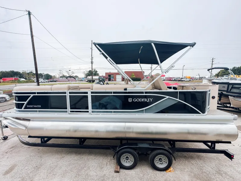 Slide: The Image of 2024 Godfrey Sweetwater 22' Rear Fish & Cruise Tritoon on trailer, with canopy. - 0