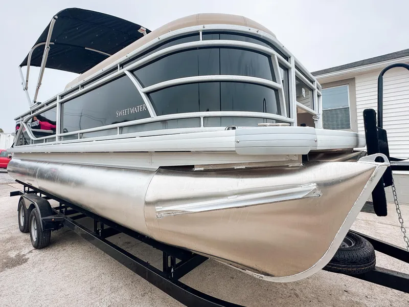 Slide: The Image of 2024 Godfrey Sweetwater 22' Rear Fish & Cruise Tritoon on trailer, sleek design, ready for adventure. - 1