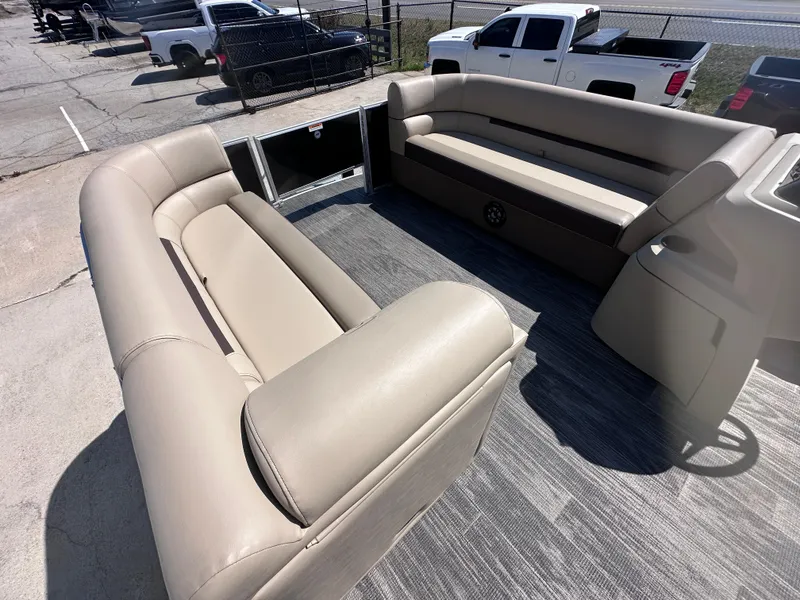 Slide: The Image of 2024 Godfrey Sweetwater 22' Tritoon interior with beige seating and spacious layout. - 6