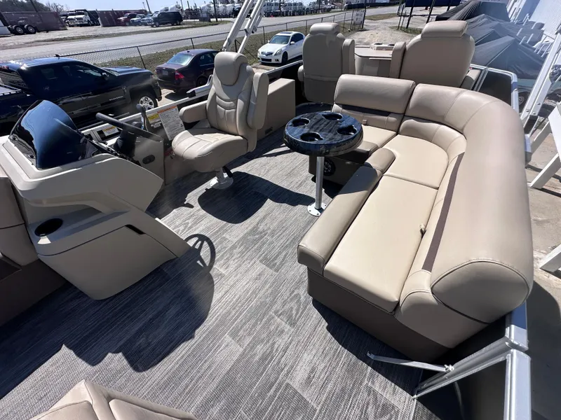 Slide: The Image of 2024 Godfrey Sweetwater 22' Tritoon with plush seating and modern helm. - 7
