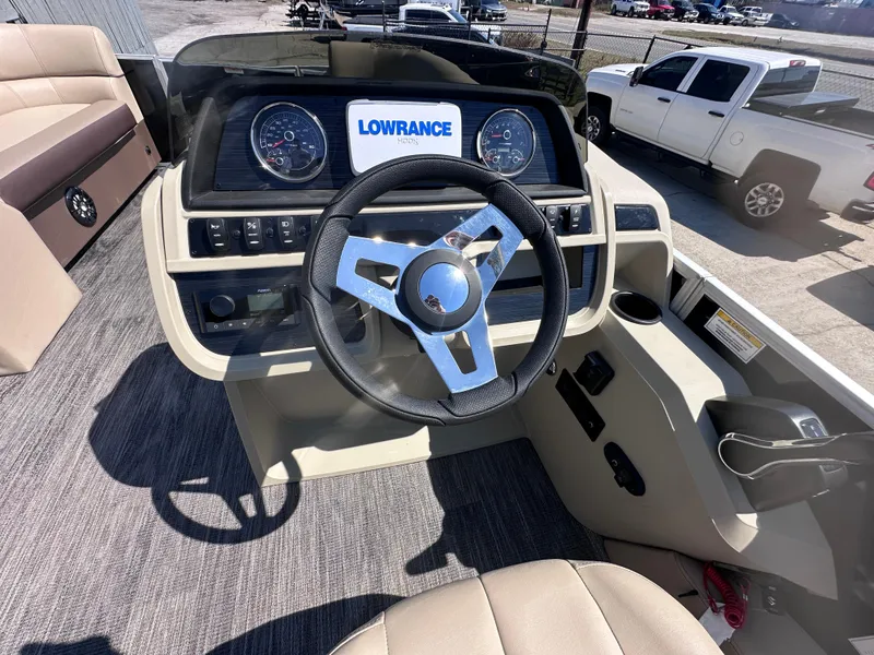 Slide: The Image of 2024 Godfrey Sweetwater 22' Tritoon dashboard with steering wheel and Lowrance display. - 9