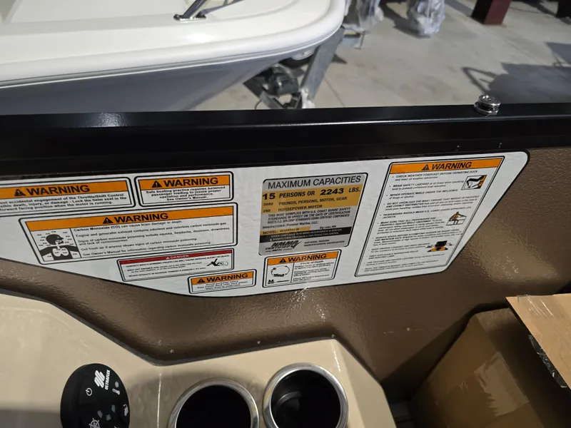 Slide: The Image of Warning labels and capacity information on 2025 Premier 230 SunSation RF boat dashboard. - 13