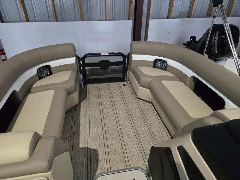Slide: The Image of 2025 Premier 230 SunSation RF boat interior with beige seating and wood flooring. - 14