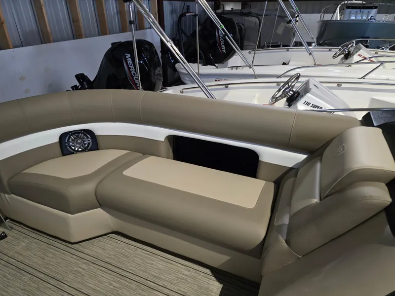 Slide: The Image of 2025 Premier 230 SunSation RF boat interior with beige seating and modern design. - 16
