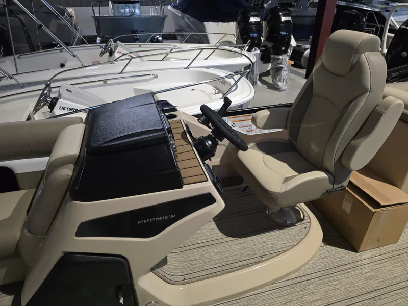 Slide: The Image of 2025 Premier 230 SunSation RF boat interior with steering console and captain's chair. - 17