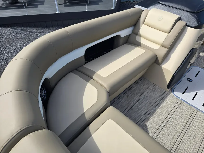 Slide: The Image of 2025 Premier 230 SunSation RF boat interior with beige seating and speaker. - 23