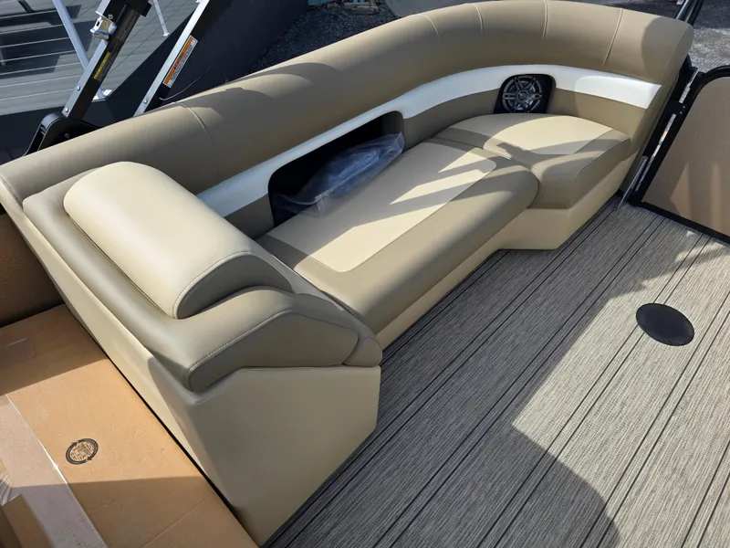 Slide: The Image of 2025 Premier 230 SunSation RF boat interior with beige seating and modern dashboard. - 28