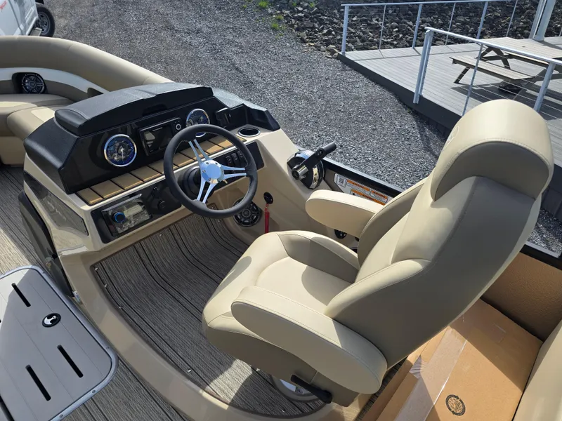 Slide: The Image of 2025 Premier 230 SunSation RF boat interior with beige seating and flooring. - 29