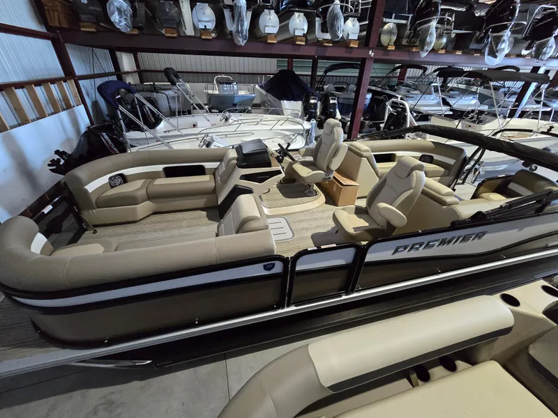 Slide: The Image of 2025 Premier 230 SunSation RF pontoon boat in showroom, beige and black design. - 4