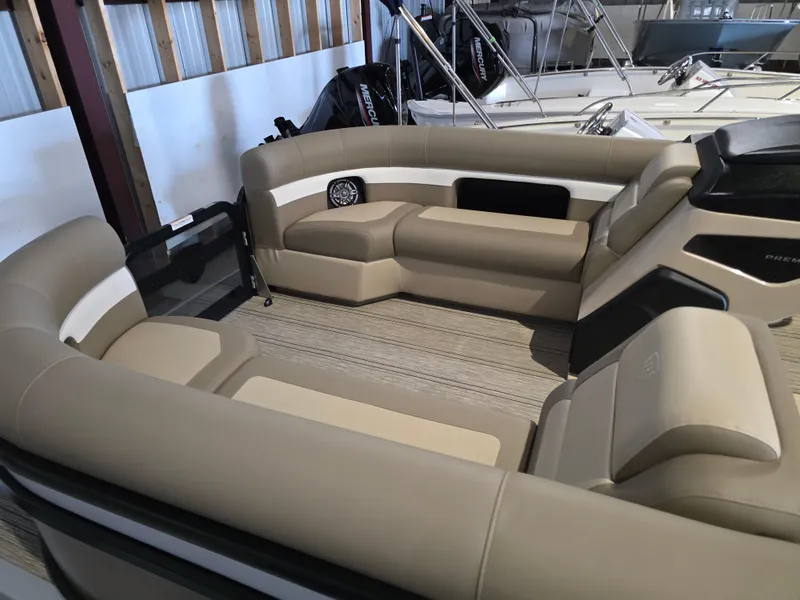 Slide: The Image of 2025 Premier 230 SunSation RF boat interior with beige seating and spacious layout. - 8
