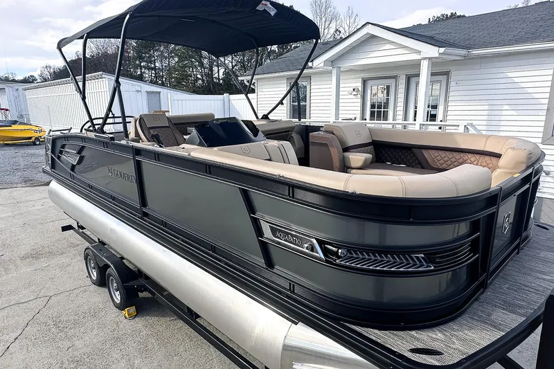 The Image of 2025 Godfrey AquaPatio 25' Flip Lounge Tritoon on trailer, featuring sleek design and spacious seating. - 0