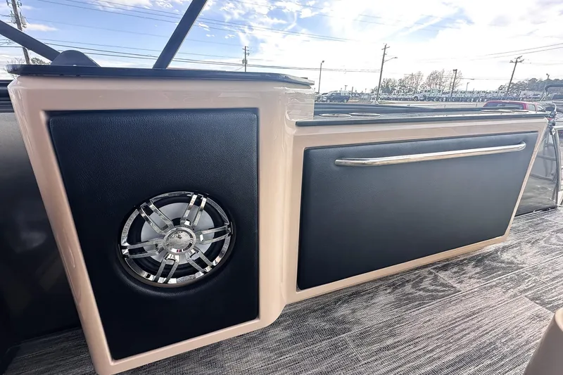 Slide: The Image of Dashboard of 2025 Godfrey AquaPatio 25' Tritoon with illuminated controls and steering wheel. - 11