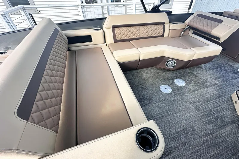 Slide: The Image of 2025 Godfrey AquaPatio 25' Tritoon interior with luxurious seating and stylish flooring. - 12