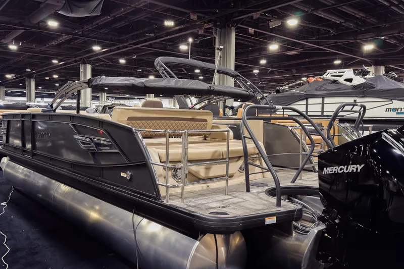 Slide: The Image of 2025 Godfrey AquaPatio 25' Flip Lounge Tritoon displayed indoors with Mercury engine. - 30