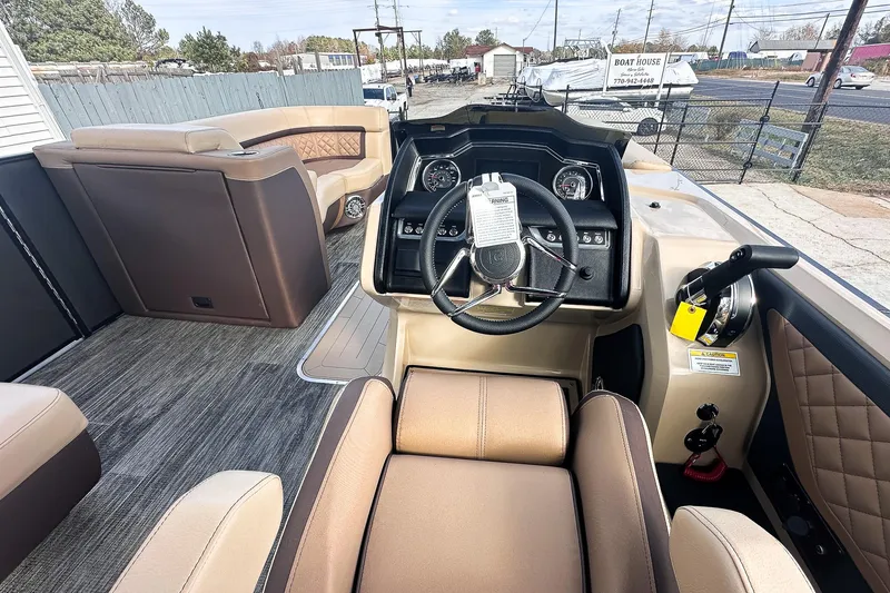 Slide: The Image of Interior view of 2025 Godfrey AquaPatio 25' Flip Lounge Tritoon, featuring steering console and seating. - 36
