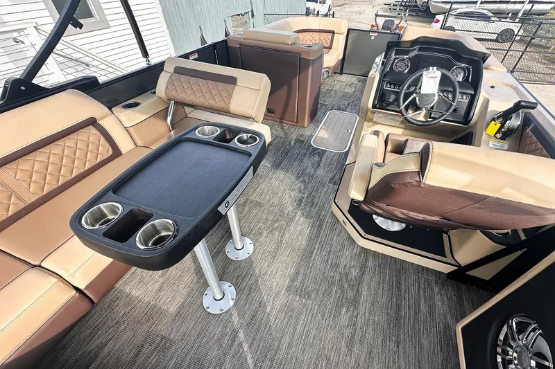 Slide: The Image of 2025 Godfrey AquaPatio 25' Tritoon interior with luxurious seating and modern helm. - 46