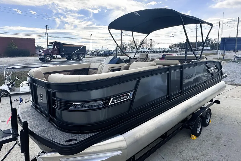 Slide: The Image of 2025 Godfrey AquaPatio 25' Flip Lounge Tritoon on trailer, featuring sleek design and canopy. - 49