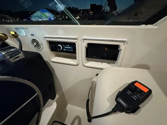 Slide: The Image of Interior cockpit of 1996 Tiara Yachts 43 Open with control panel and radio. - 11