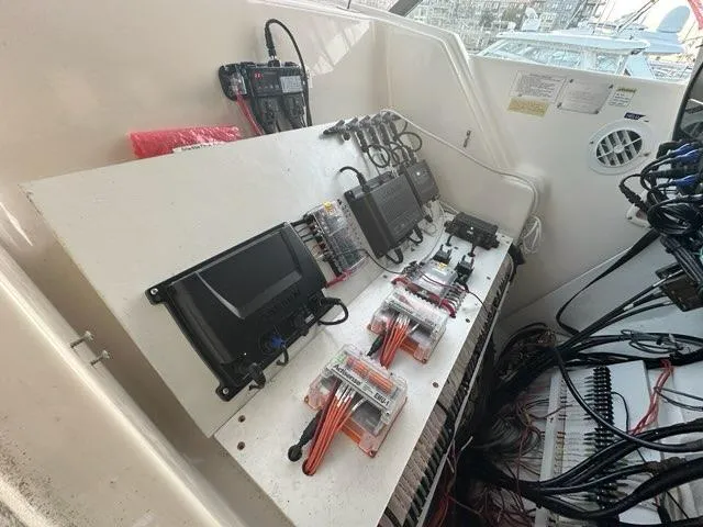 Slide: The Image of 1996 Tiara Yachts 43 Open electronic control panel with wiring and equipment. - 12