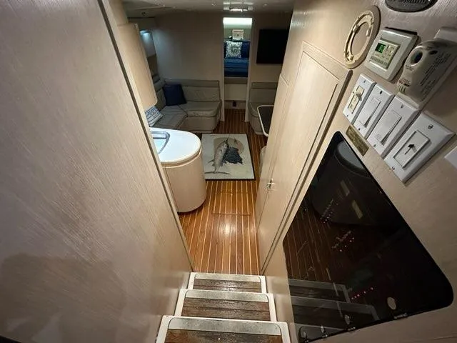 Slide: The Image of Interior of 1996 Tiara Yachts 43 Open, featuring wood flooring and cozy seating area. - 14